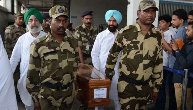 Indian Central Industrial Security Force (CISF) personnel carry the coffin of Nand Lal, who was killed in Iraq, at the International Airport in Amritsar