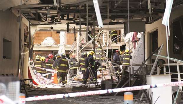 Firefighters work inside a clinic, after an explosion by an apparent gas leak, that resulted in death, injuries and serious damage to buildingu2019s structure in Concepcion, Chile, yesterday.