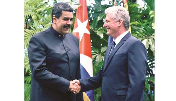 Cuban President Miguel Diaz Canel (right) shakes hands with Venezuelan President Nicolas Maduro at the Revolution Palace in Havana on Friday.