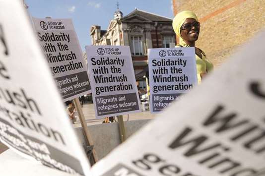 A woman is seen among placards at an event on Friday in Windrush Square to show solidarity with the Windrush generation, in the Brixton district of London.