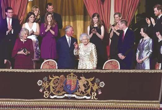 Queen Elizabeth, surrounded by members of the royal family, waves during the special concert at the Royal Albert Hall in London.