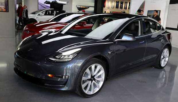 A Tesla Model 3 is seen in a showroom in Los Angeles