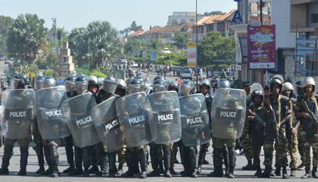 Riot police walk in formation as they prepare to disperse opposition demonstrators protesting against new electoral laws in Antananarivo