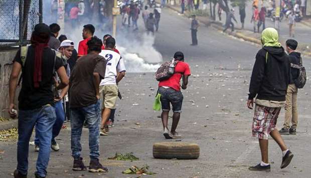 Students clash with riot police agents close to Nicaragua's Technical College during a protest against government's reforms in the Institute of Social Security (INSS) in Managua.