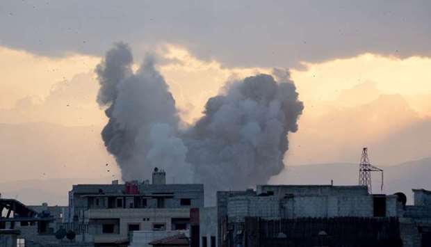 Smoke billows in a southern district of the Syrian capital Damascus, during regime strikes targeting the Islamic State group in the Palestinian camp of Yarmouk, and neighbouring districts