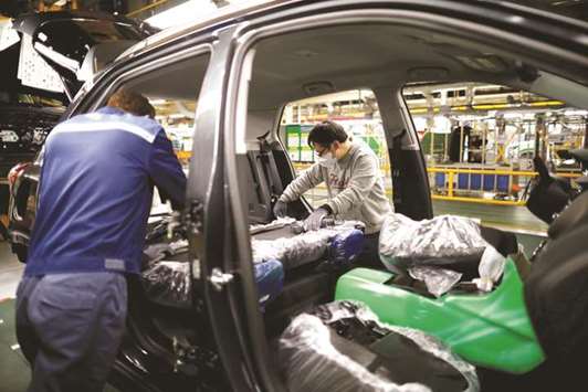 Employees work at an assembly line of GM Koreau2019s Bupyeong plant in Incheon, South Korea. The auto firm said yesterday its domestic sales for March more than halved from a year earlier, deepening a decline in the aftermath of the announcement of planned restructuring of the money-losing operation.