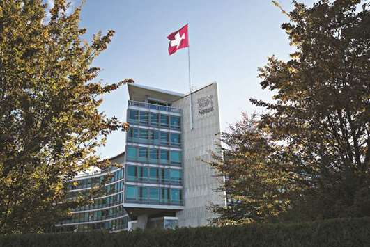 A Swiss national flag flies above the headquarters of the Nestle headquarters in Vevey. Nestleu2019s 2.8% underlying sales growth only got a 0.2% boost from higher prices.