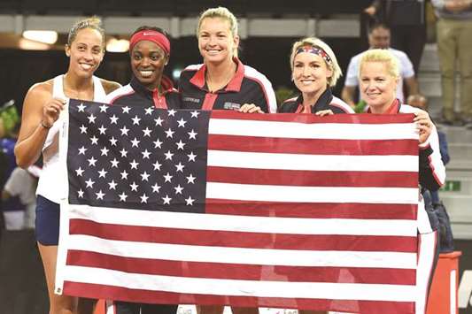 (L-R) USAu2019s Madison Keys, Sloane Stephens, CoCo Vandeweghe, Bethanie Mattek-Sands, and Kathy Rinaldi-Stunkel pose with a US flag after their victory in the Fed Cup semi-final against France at the Arena Stadium in Aix en Provence, France, yesterday. (AFP)