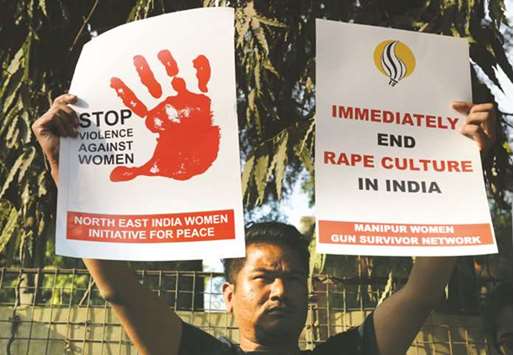 A social activist hold a placard during a protest against a rape in New Delhi.