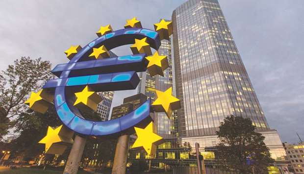 A euro sign sculpture stands illuminated in front of the European Central Bank (ECB) headquarters in Frankfurt, Germany.