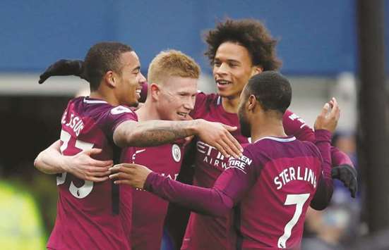 Manchester Cityu2019s Gabriel Jesus (left) celebrates scoring a goal with teammates Kevin De Bruyne, Raheem Sterling and Leroy Sane  during the match against Everton in Liverpool on Saturday. (Reuters)