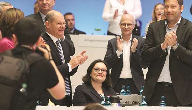 Nahles is applauded by German Finance Minister and Vice-Chancellor Olaf Scholz (left). SPD general secretary Lars Klingbeil (right), and other senior party officials after she was elected as party chairwoman during a party rally in Wiesbaden, Germany.