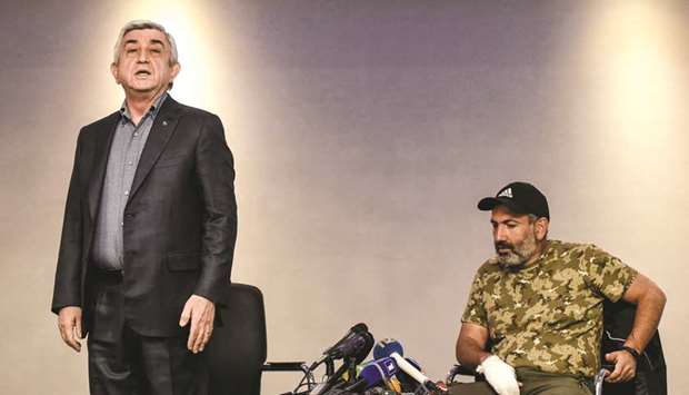 Prime Minister Sarkisian rises to leave a televised meeting with anti-government protest leader Pashinyan shortly after it began in a hotel in Yerevan.