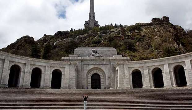 A woman takes pictures at the Valle de los Caidos (Valley of the Fallen) mausoleum outside Madrid
