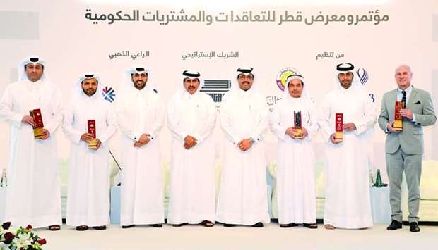HE al-Sada, HE Sheikh Abdulla and al-Khalifa with the winners of National Procurement Awards at the third edition of Moushtrayat.