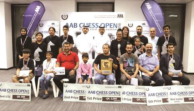 Qatar Chess Association president Mohamed al-Medaihki, and other QCA and AAB officials pose with the winners of the inaugural AAB Chess Open.