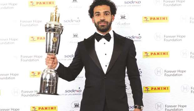 Liverpoolu2019s Mohamed Salah celebrates with the Professional Footballersu2019 Association Player of the Year trophy.