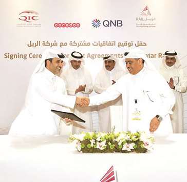 QNB Group CEO Ali Ahmed al-Kuwari (right) and Qatar Railu2019s managing director and CEO engineer Abdulla Abdulaziz T al-Subaie shake hands after signing the agreement as HE the Prime Minister and Interior Minister Sheikh Abdullah bin Nasser bin Khalifa al-Thani and HE the Minister of Transport and Communications Jassim Seif Ahmed al-Sulaiti look on.