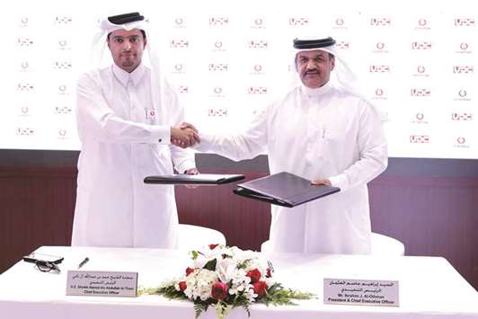 Vodafone Qatar CEO Sheikh Hamad Abdulla Jassim  al-Thani and UDC President & CEO Ibrahim Jassim  al-Othman shake hands after signing the agreement  during Cityscape Qatar 2018.