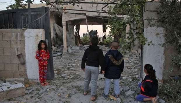 Palestinian children check the house of a man suspected of murdering an Israeli rabbi, after it was demolished by Israeli forces in the West Bank city of Jenin on Tuesday.