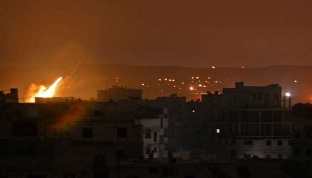 A picture taken in the Yarmuk Palestinian refugee camp in southern Damascus on April 24, 2018 shows fire billowing in the area during Syrian army shelling.