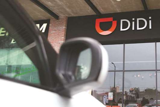 The logo of Chinese ride-hailing firm Didi Chuxing is seen at its new drivers centre in Toluca, Mexico. The firm has put together teams of automotive designers and engineers, and is now looking to work with established car makers to develop u201cpurpose-builtu201d vehicles, a move that could shake up the auto market in China and beyond, sources said.