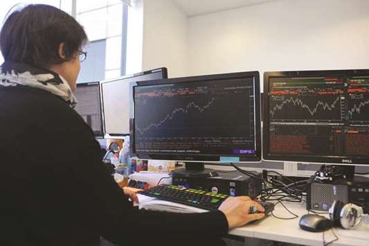A trader is seen at the London Stock Exchange. The FTSE 100 gained 0.4% to 7,425.40 points yesterday.