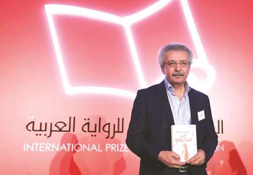 Ibrahim Nasrallah poses for a photo after winning the 2018 International Prize for Arabic Fiction in Abu Dhabi, yesterday.