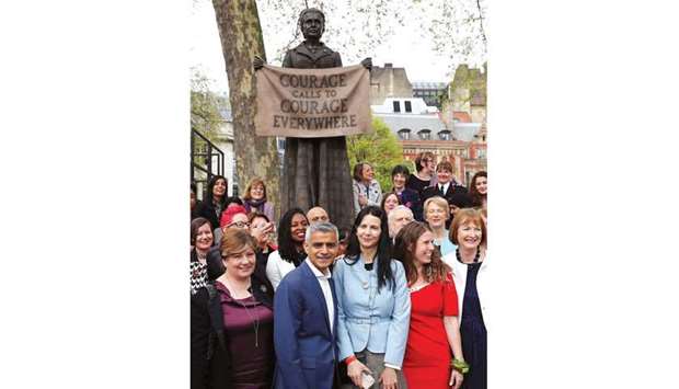 Artist Gillian Wearing (centre right) poses for a photograph with London Mayor Sadiq Khan (centre left) following the unveiling of her sculpture of suffragist and womenu2019s rights campaigner Millicent Fawcett in Parliament Square in London yesterday.