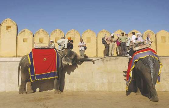 Tourists get off an elephant after riding them into the Amber Fort on the outskirts of Jaipur. Dozens of elephants used for tourist rides at the fort are blind or suffering other ailments, Peta said, calling for the practice to end.