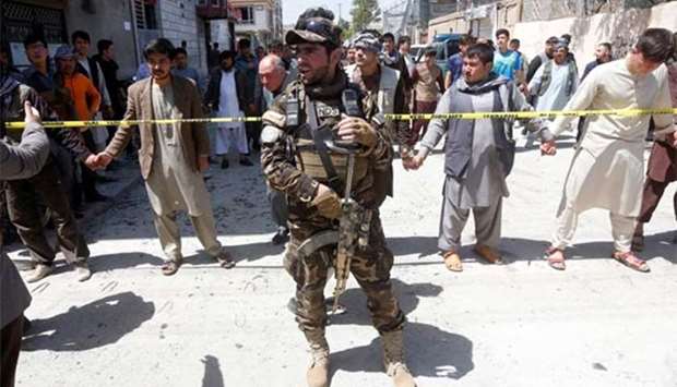 An Afghan security forces member stands guard at the site of a suicide bomb attack in Kabul earlier this week.
