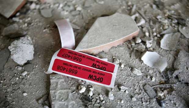 Labels of  OPCW are seen inside a damaged house in Douma in Damascus, Syria on Monday