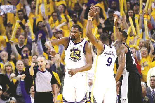 Kevin Durant (left) of the Golden State Warriors celebrates after the win over San Antonio Spurs in the Game Five of Round One of the 2018 NBA Playoffs in Oakland, California, on Tuesday. (AFP)