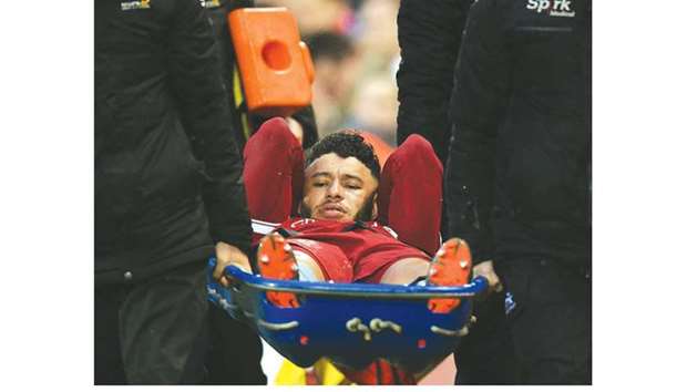 Liverpoolu2019s Alex Oxlade-Chamberlain is stretchered off after he injured his knee during the Champions League match against Roma in Liverpool. (AFP)