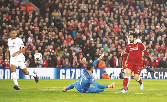 Liverpoolu2019s Mohamed Salah (right) scores against Roma during the Champions League first leg semi-final in Liverpool, Britain on Tuesday night. (Reuters)