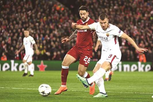 Romau2019s Edin Dzeko (right) and Liverpoolu2019s Danny Ings vie for the ball during Champions League first leg semi-final. (AFP