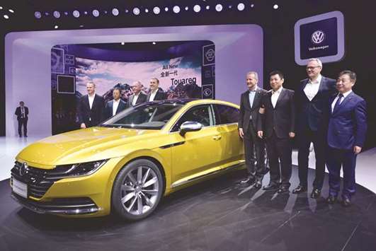 Herbert Diess, CEO of Volkswagen (4th from right), poses with officials and the next generation Volkswagen CC 380 TSI car during its launch at the Beijing Auto Show yesterday.