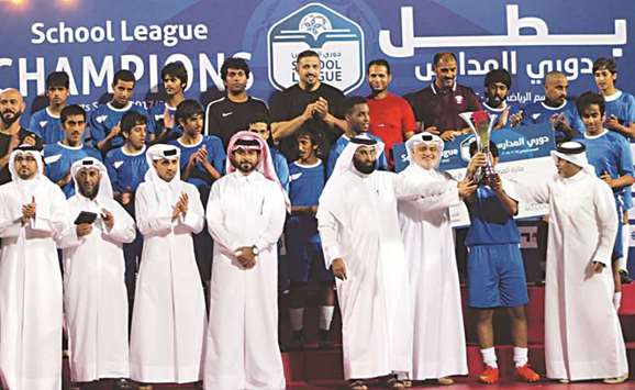 Al Shahania High School players celebrate with School League trophy.