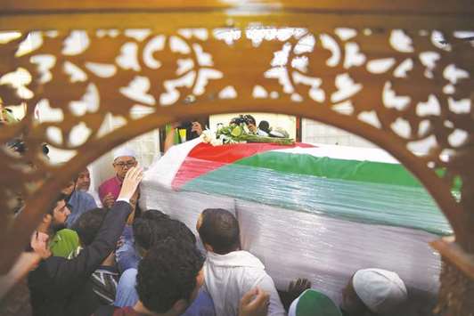 Mourners carry the coffin of late Palestinian professor Fadi al-Batsh after offering special prayers at a mosque in Kuala Lumpur yesterday.