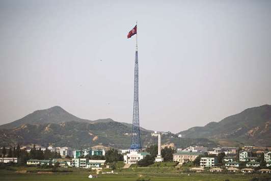 A North Korean flag flutters on top of a tower at the propaganda village of Gijungdong in North Korea, in this picture taken near the truce village of Panmunjom, South Korea.