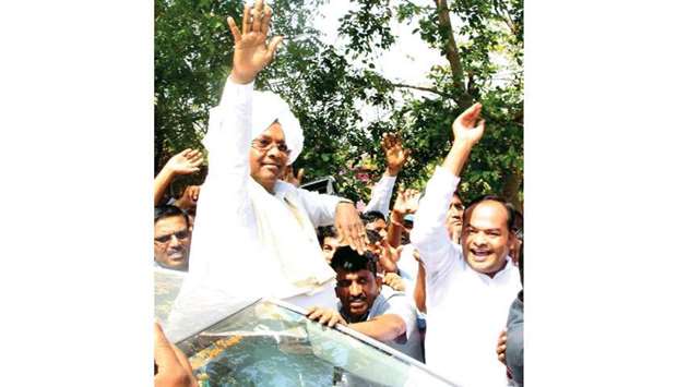 Karnataka Chief Minister Siddaramaiah waves to supporters in Bagalkot.