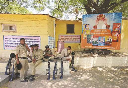 Policemen rest as they guard inside Asaram Bapuu2019s ashram in Ahmedabad yesterday.