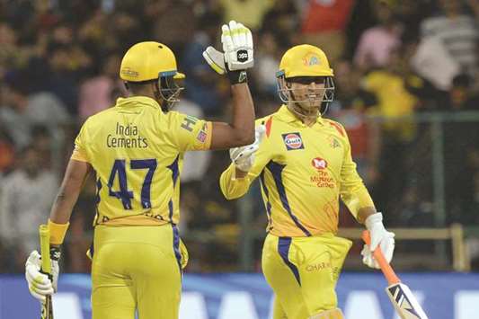 Chennai Super Kings batsman DJ Bravo (left) celebrates his teamu2019s victory with captain Mahendra Singh Dhoni against Royal Challengers Bangalore at The M. Chinnaswamy Stadium in Bangalore yesterday. (AFP)