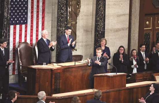 House Speaker Paul Ryan (right) and Vice President Mike Pence applaud after Franceu2019s President Emmanuel Macron addressed a joint meeting of Congress inside the House chamber at the US Capitol in Washington, DC, yesterday.