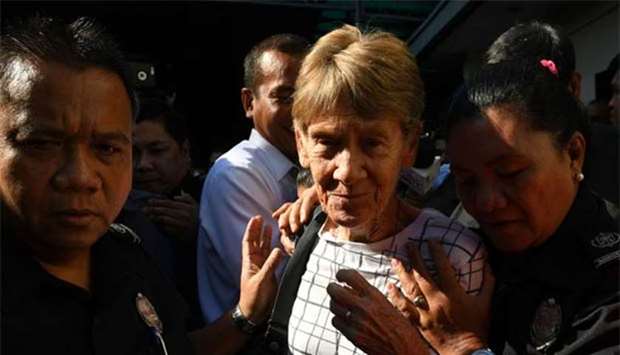 Australian nun Sister Patricia Fox being escorted by immigration officers while leaving a detention facility after her release in Manila last week.