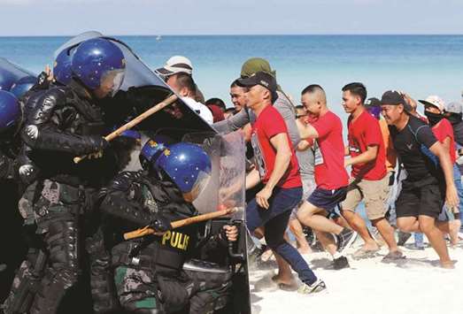 Policemen stage a mock protest dispersal during a drill, one day before the temporary closure of the holiday island Boracay, yesterday.