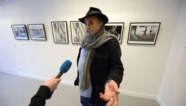 Magnum photographer Abbas answers journalists' questions in front of some of his pictures in Paris. File picture