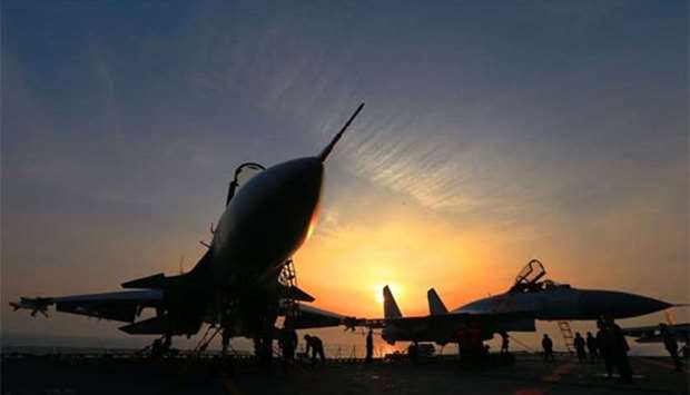 J15 fighter jets on China's sole operational aircraft carrier, the Liaoning, are seen during a drill at sea this week.