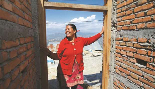 Sharmila Tamang in one of the houses she is building, after training as a mason to help with post-earthquake reconstruction.