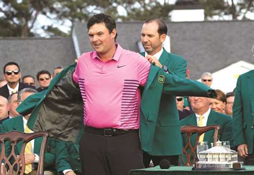 In this April 8, 2018, picture, Patrick Reed of the US is presented with the green jacket by Sergio Garcia of Spain after the former won the Masters Tournament in  Augusta, Georgia. (AFP)